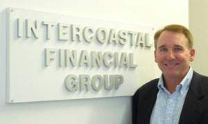 Chris Berkeley standing next to Intercoastal Financial Group sign