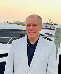 David Vedda standing in front of a boat