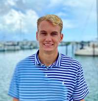 Hunter Kraaz smiling and standing near water