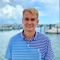 Hunter Kraaz smiling and standing near water