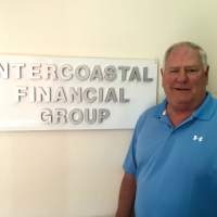 Jr. Bates standing next to the Intercoastal Financial Group sign