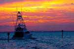 Large fishing boat going out for a sunset cruise in Destin, Florida
