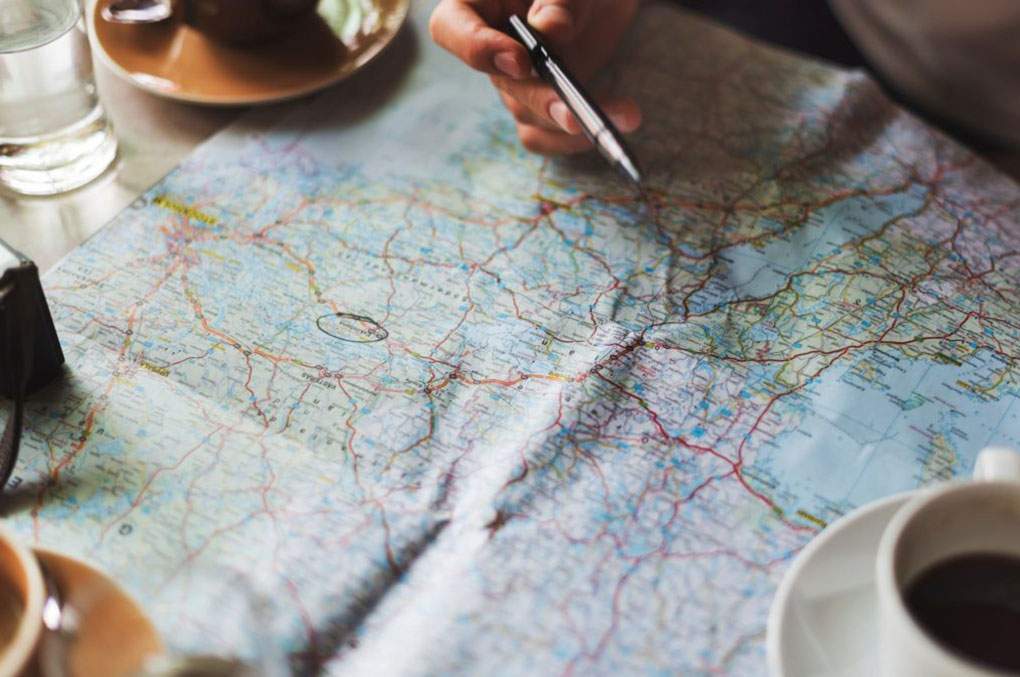 People enjoying coffee while looking at a map